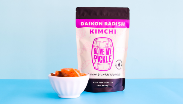 Daikon Radish Kimchi package with pink label and prepared kimchi in a white bowl on a blue background