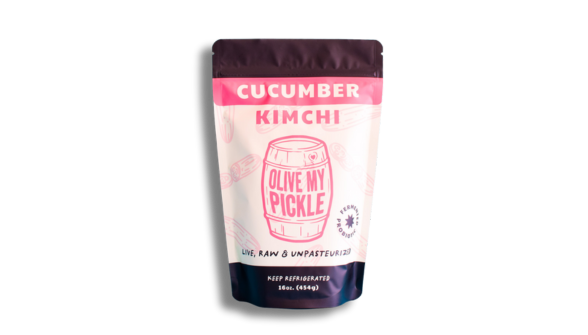 Kimchi pickle, a fermented food product, in a package labeled "KIMCHI" with a picture of a cucumber