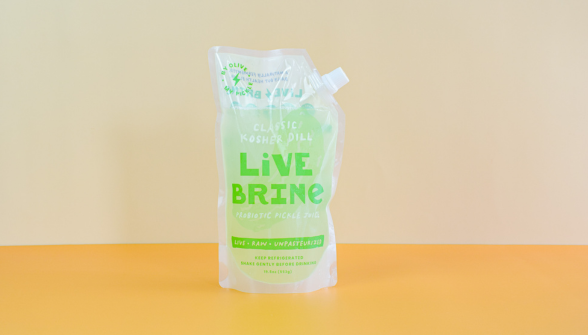 Clear pouch of Kosher Dill Live Brine with green text on a beige and orange background