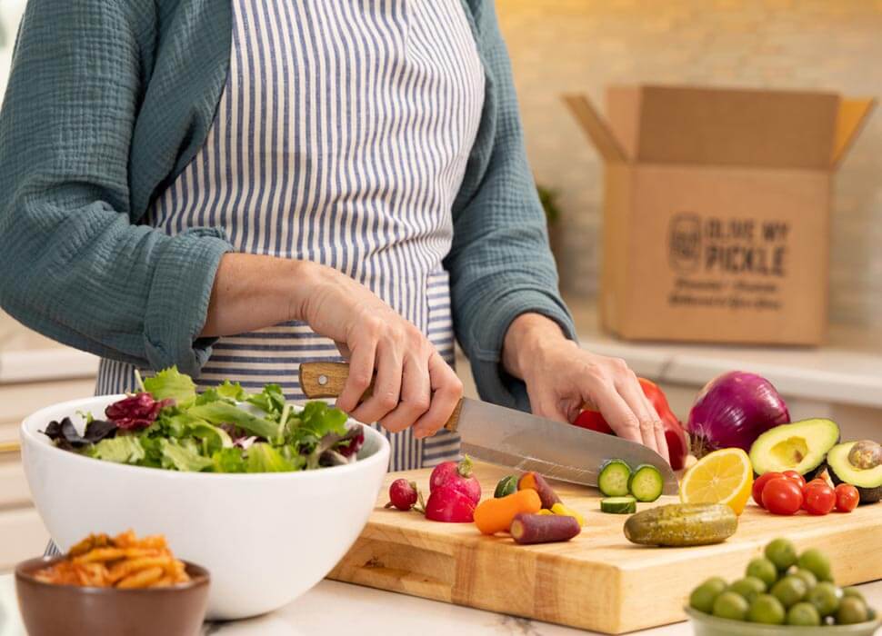 Hands chopping fresh ingredients at a cutting board
