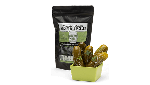 Pickles in bowls front of their packaging